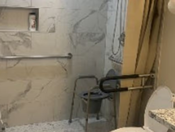 Accessible walk-in shower with safety grab bars