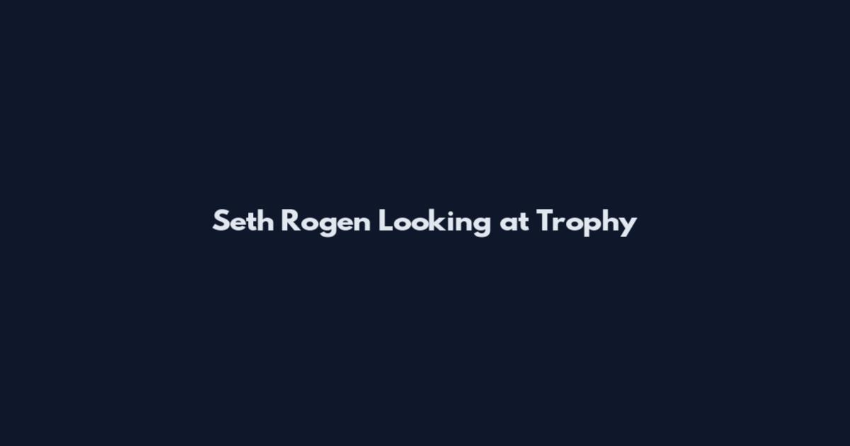 Seth Rogen Looking at Trophy
